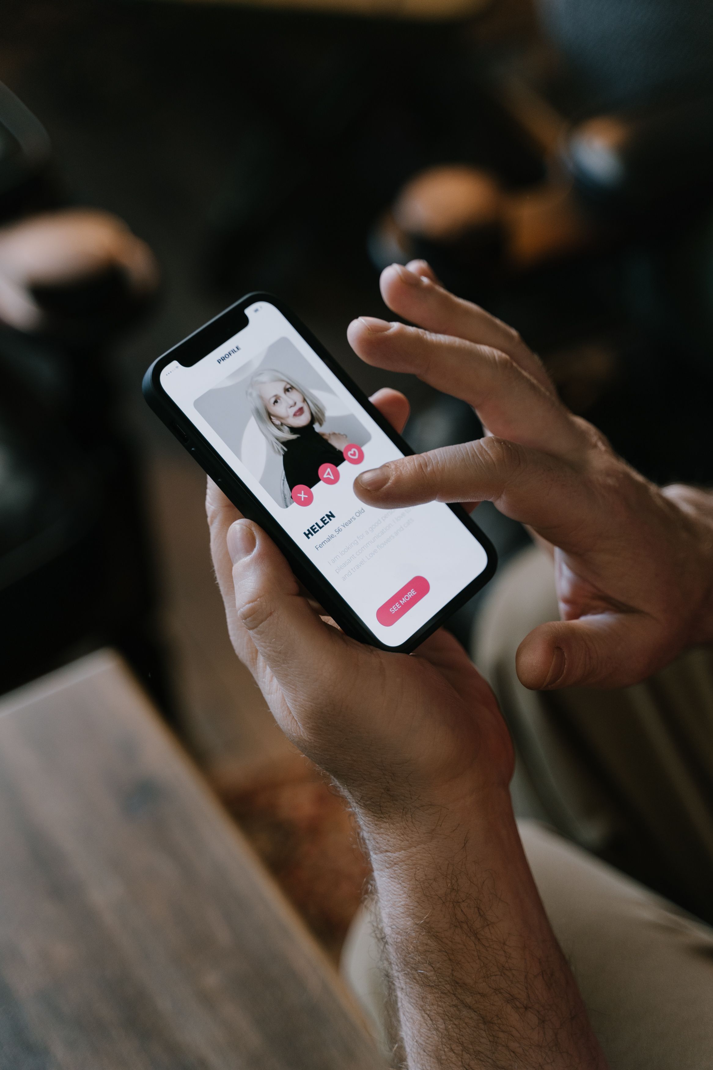 Close-up of hands swiping a dating app on a smartphone
