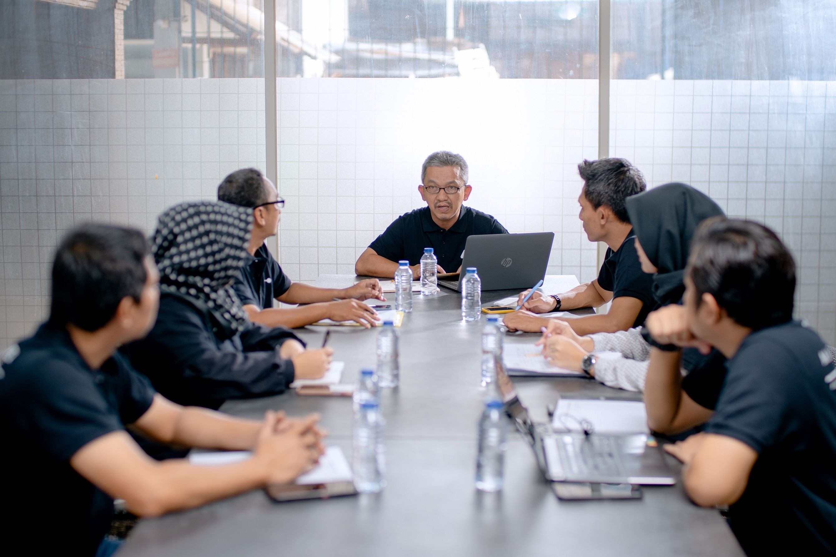 Professional team meeting around a conference table in an office setting