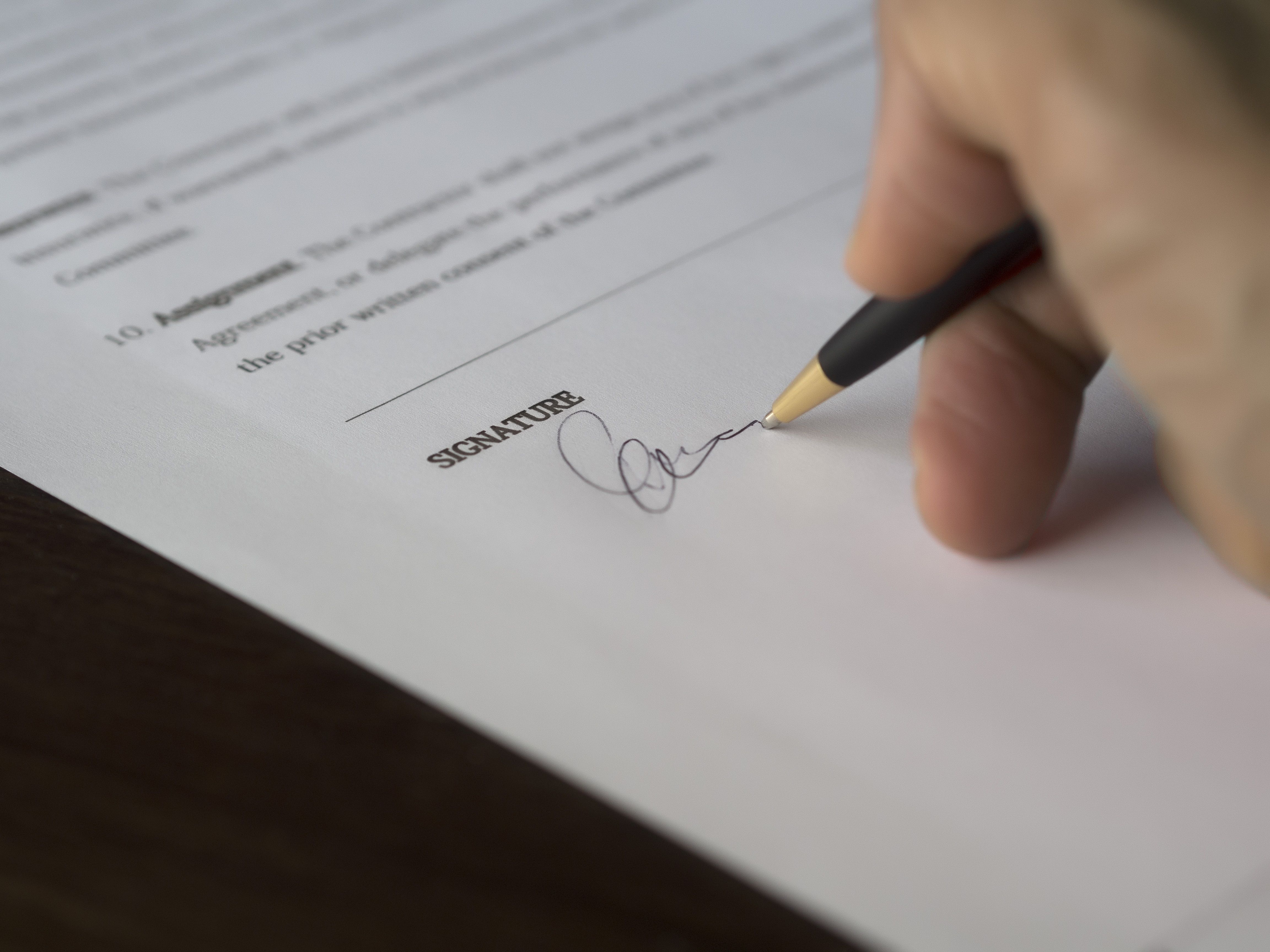 Hand signing a formal litigation funding agreement contract