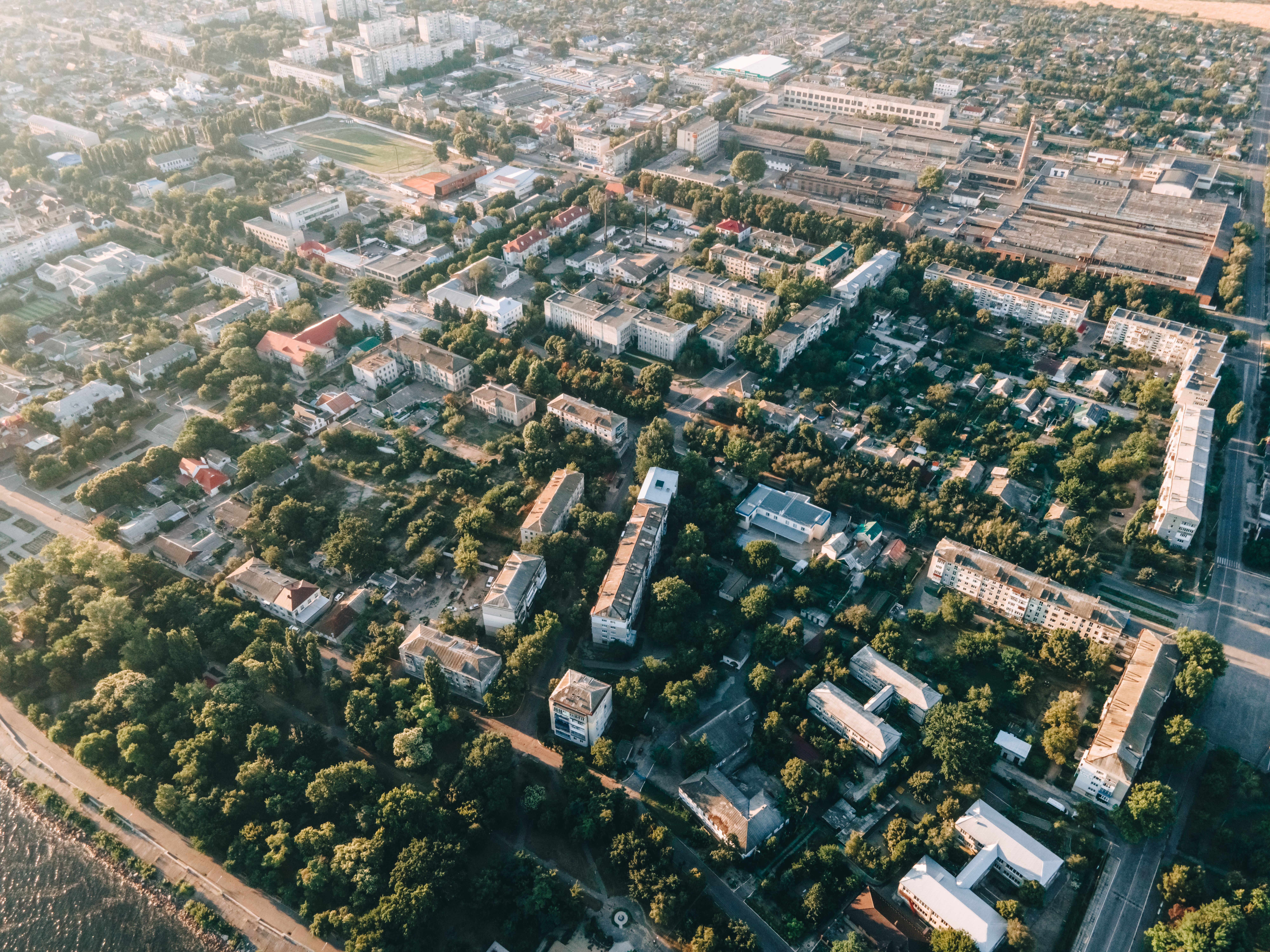 Aerial view of an urban region with roads, housing, and green spaces, illustrating long-term development planning.