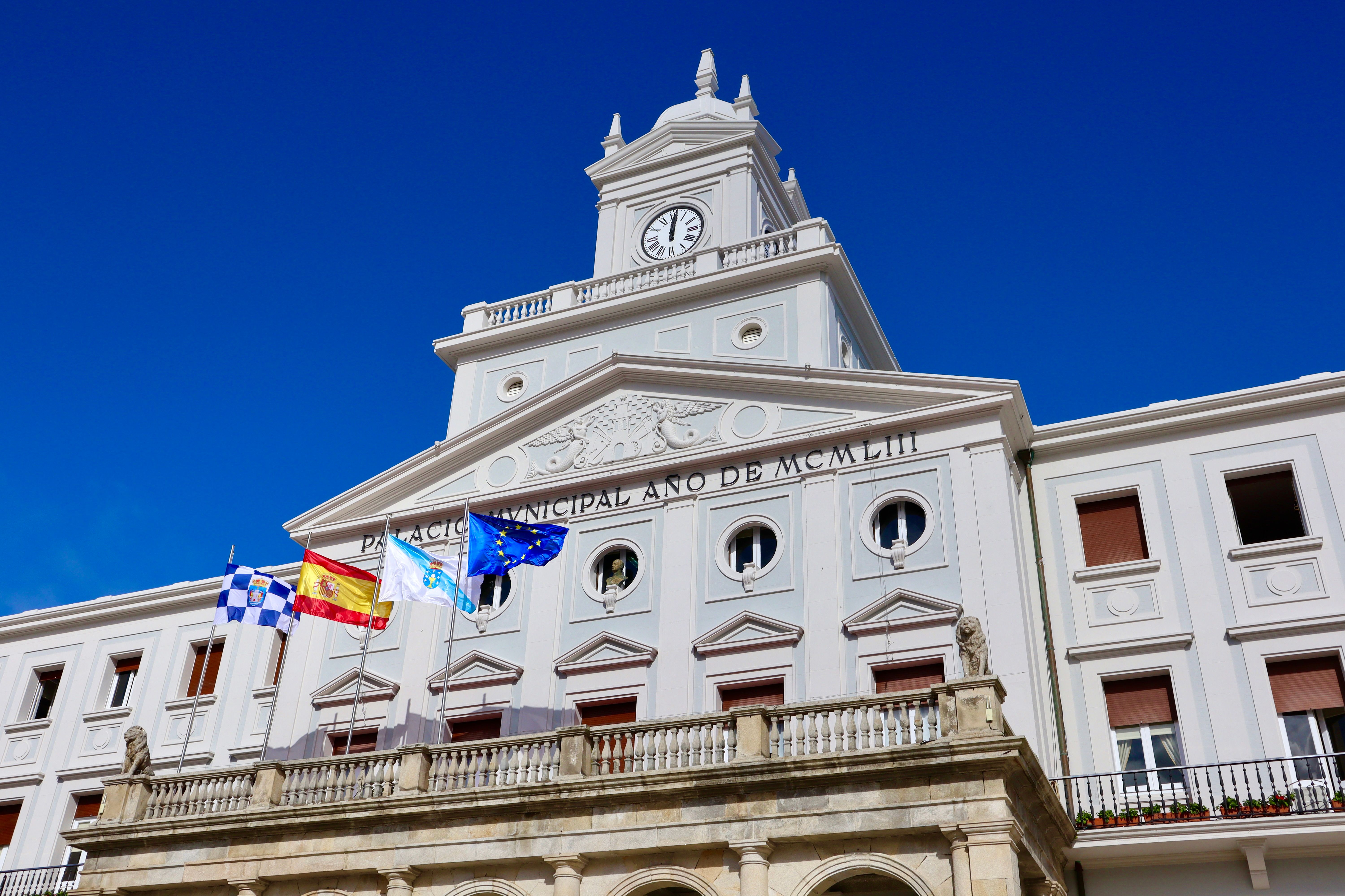 Municipal palace with flags, representing regional government institutions and civic leadership.