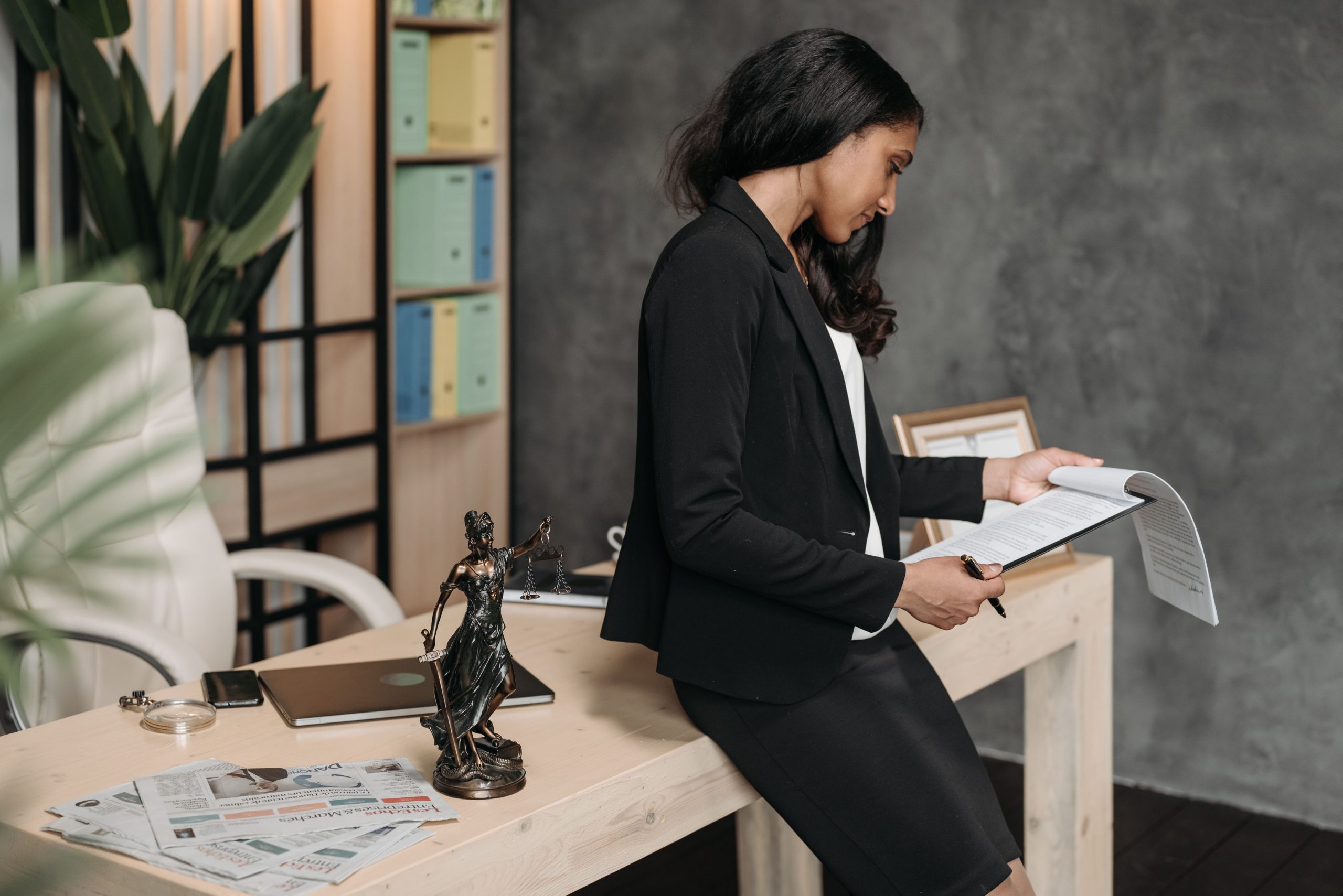 Attorney reviewing litigation funding documents at a law office desk